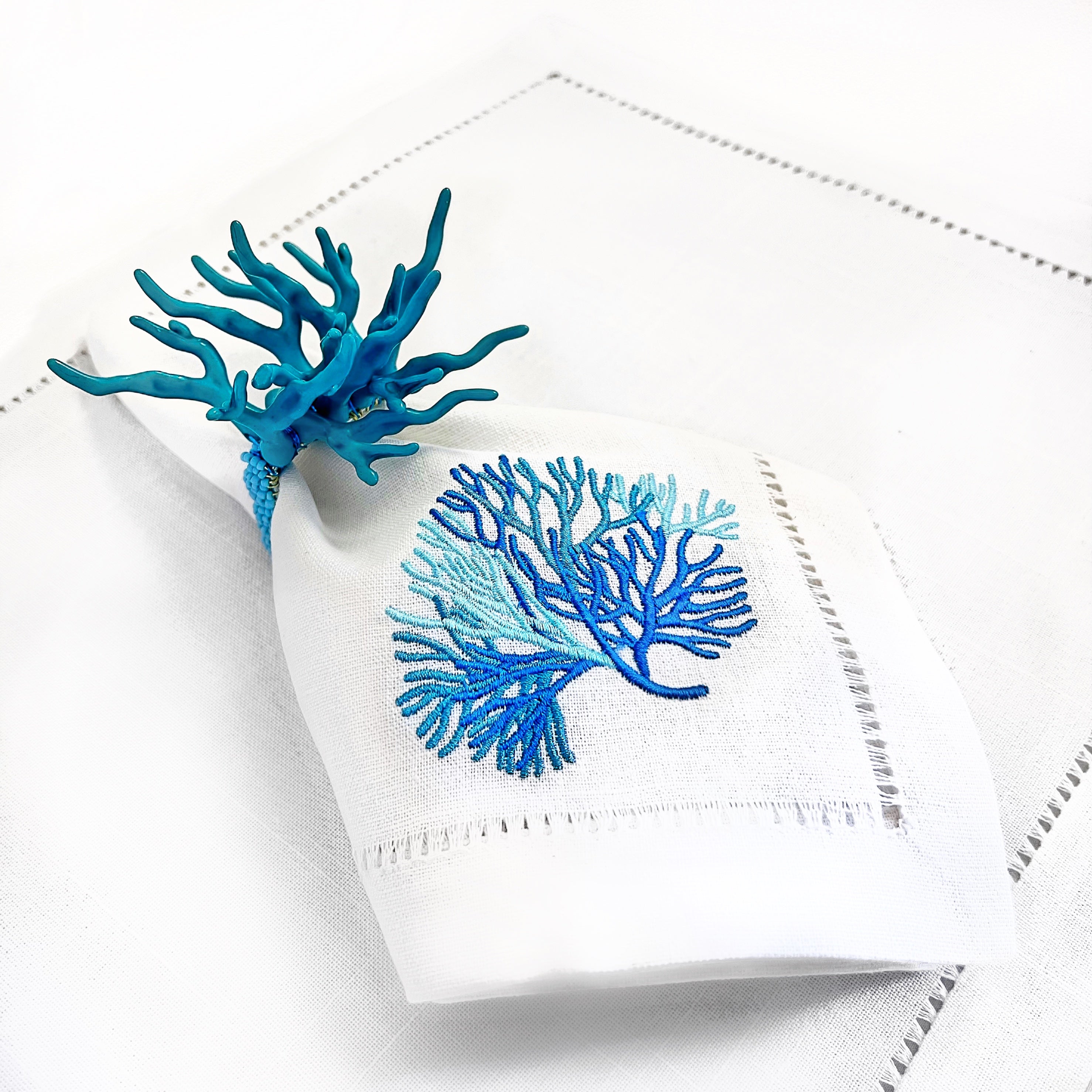 Tablescapes and table accessories, beaded napkin rings, embroidered linen napkins and placemats.