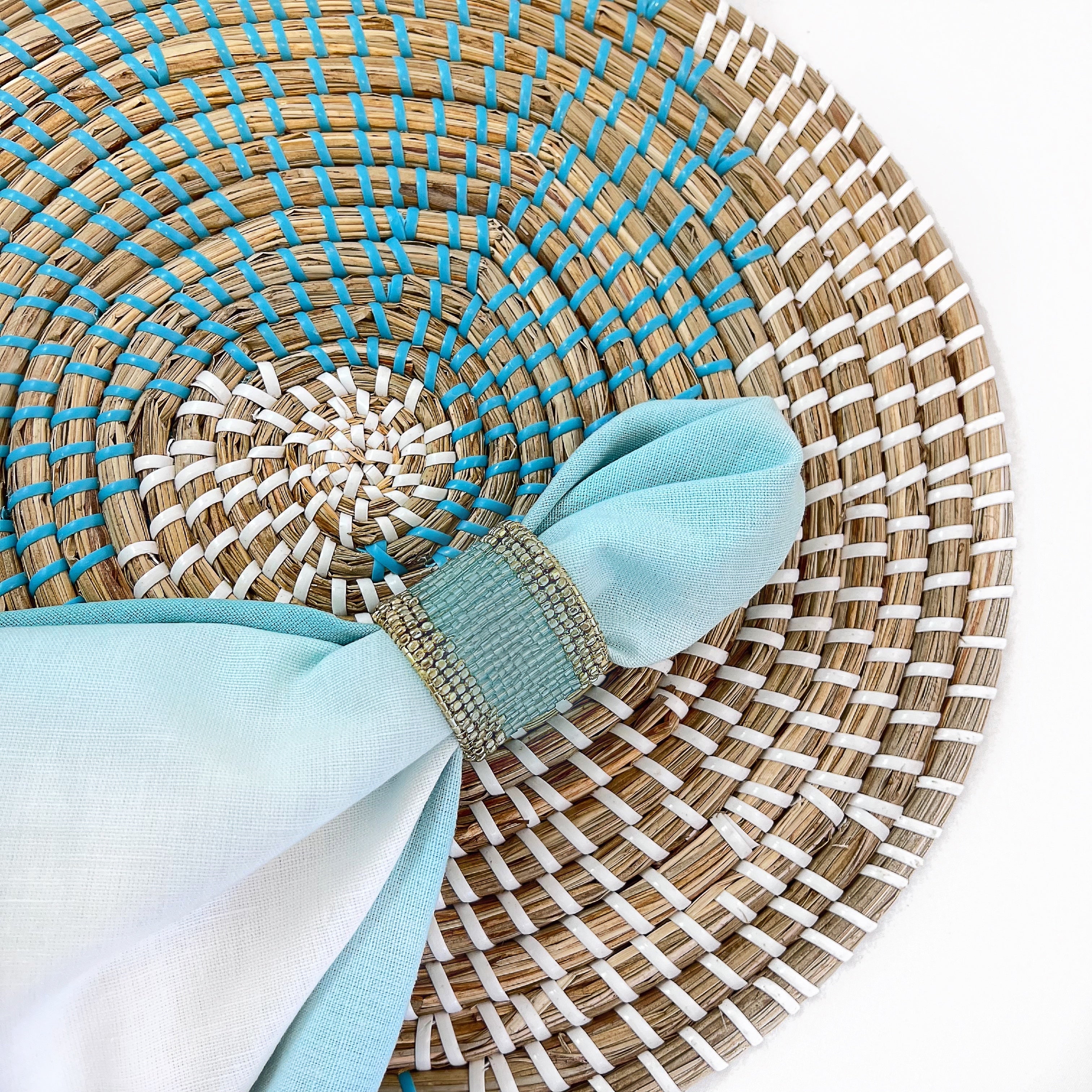 Tablescapes and table accessories, beaded napkin rings, linen napkins and placemats.