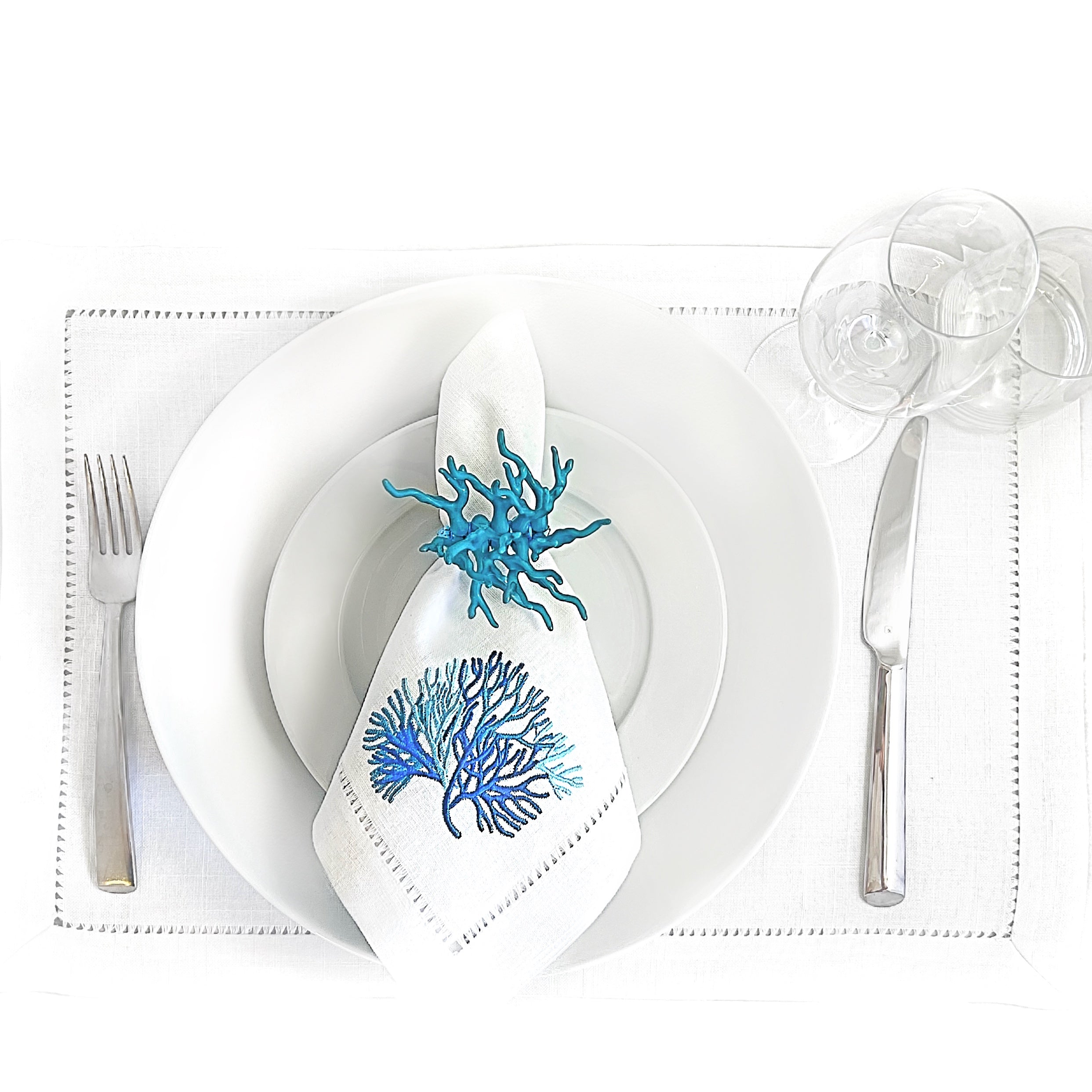 Tablescapes and table accessories, beaded napkin rings, hemstitched linen napkins and placemats.