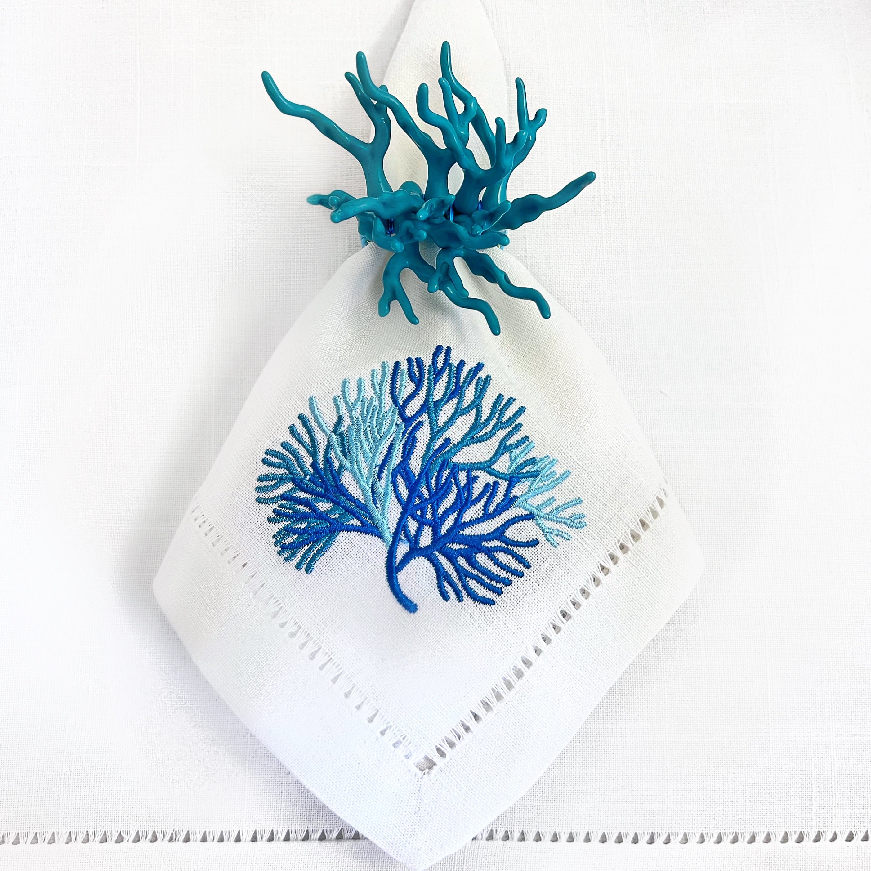 Tablescapes and table accessories, coral beaded napkin rings, linen napkins and placemats.