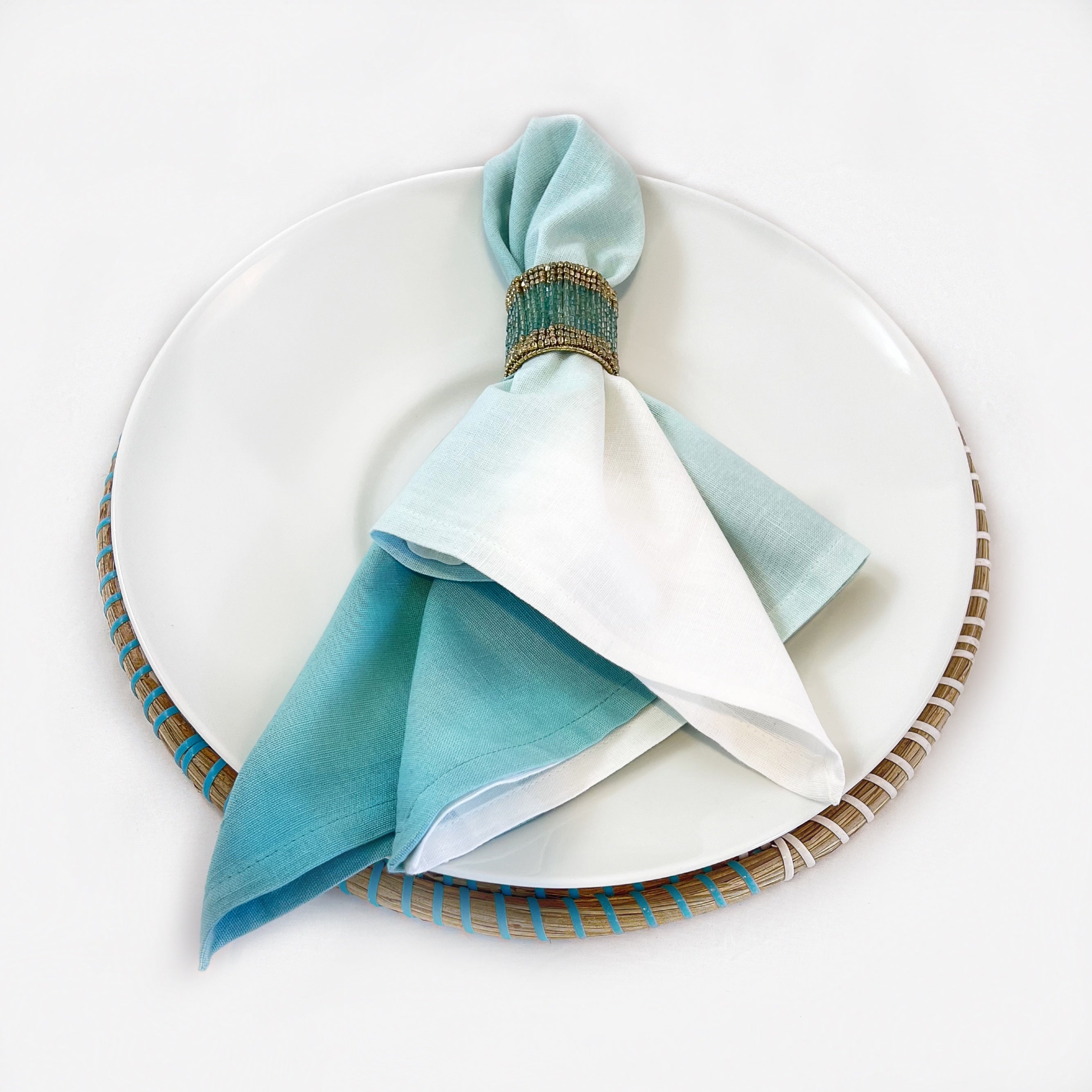 Tablescapes and  table accessories, beaded napkin rings, linen napkins and placemats.