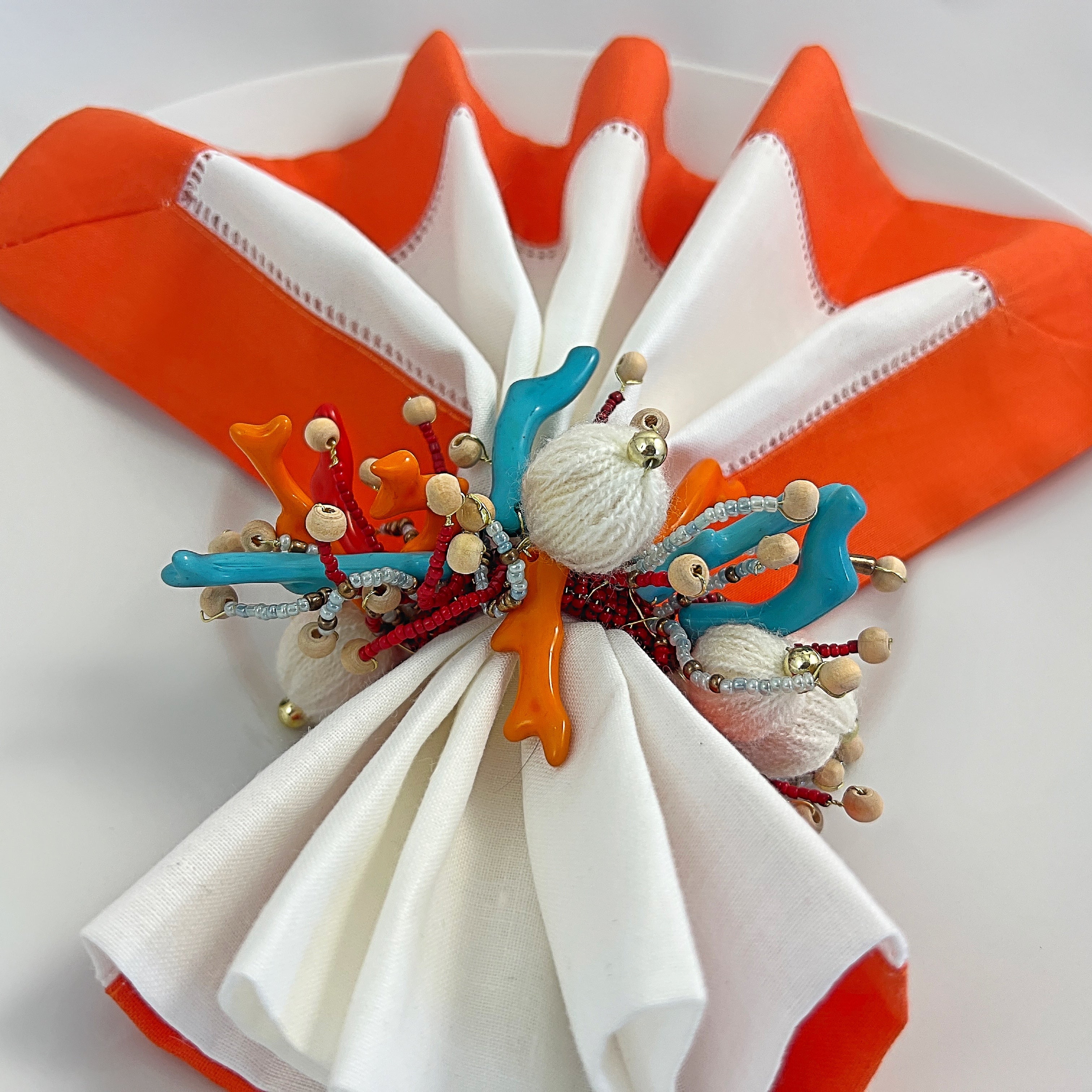 Tablescapes and  table accessories, beaded napkin rings, linen napkins and placemats.